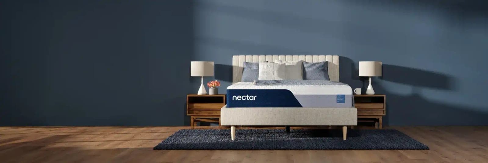 A Nectar mattress on an upholstered bed in a blue bedroom