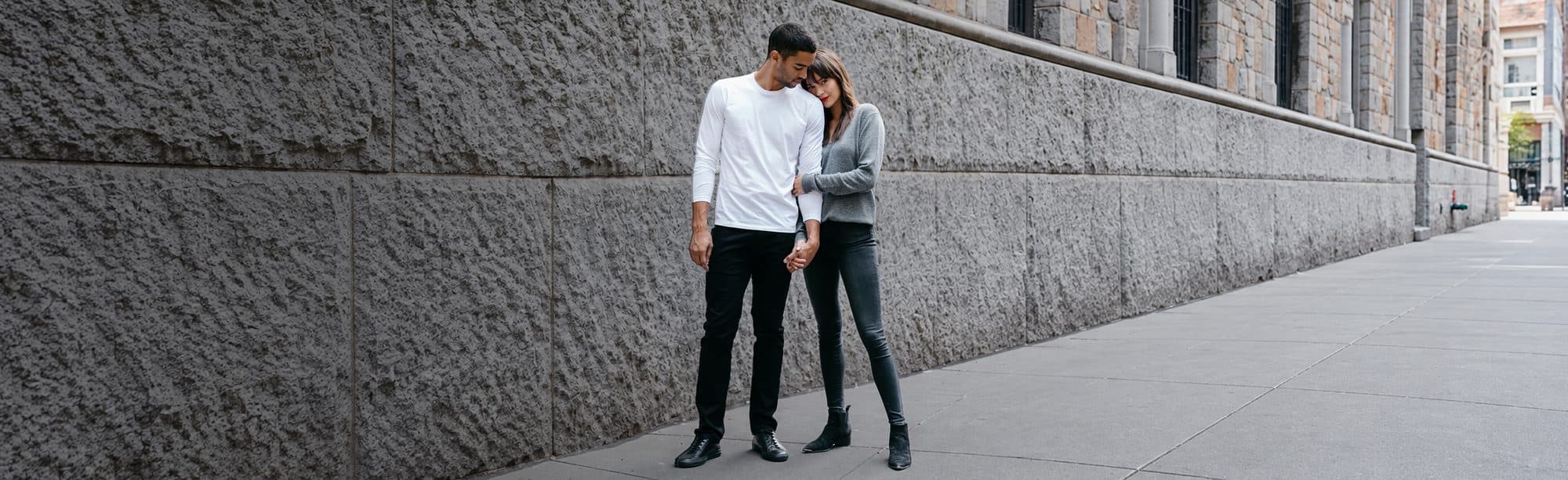Two people in Mott & Bow denim and tees on a city street